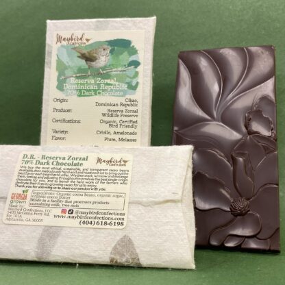 Zorzal Chocolate bar showing front and back of paper wrapper and an unwrapped chocolate bar with a floral design