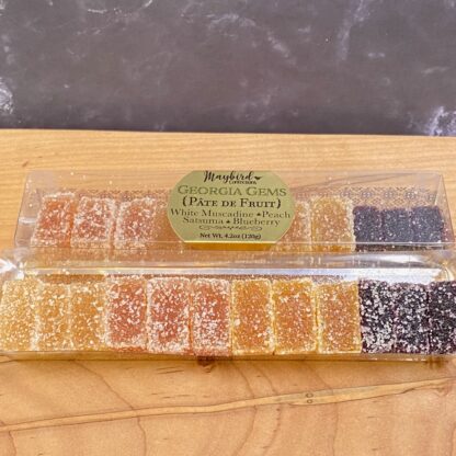 12 piece box of Pate de Fruit, open to show flavors: muscadine, peach, satsuma orange, and blueberry.