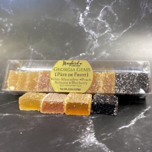 Georgia Gems Pate de Fruit 12 pc box on table. White muscadine, peach, satsuma orange, and blueberry.