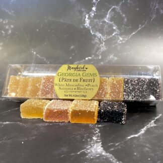 Georgia Gems Pate de Fruit 12 pc box on table. White muscadine, peach, satsuma orange, and blueberry.